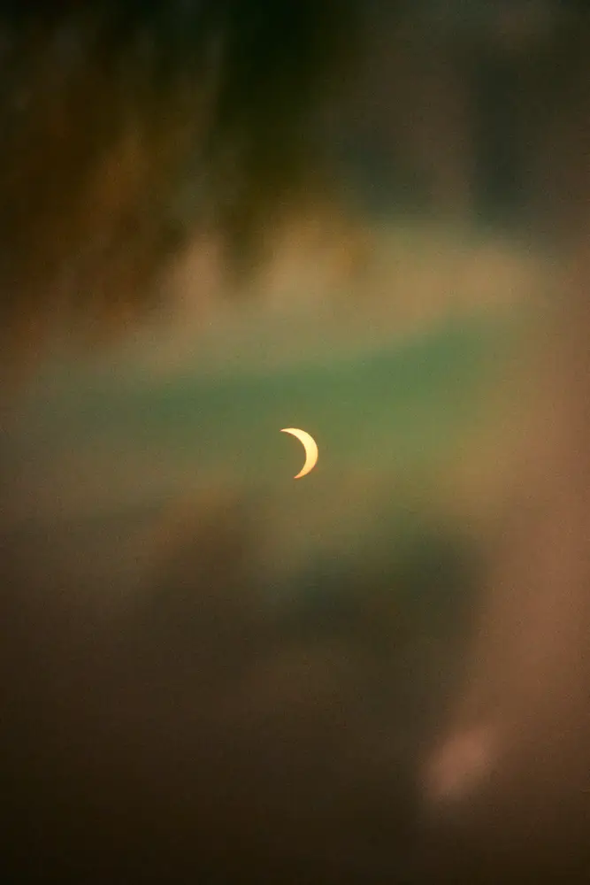 Shot through a sun filter that was held infront of the camera. So the stuff around the sun are reflections.